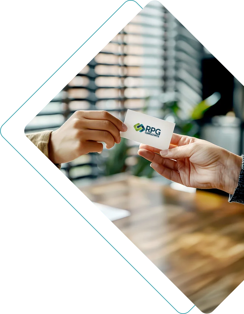 Person handing a referral business card to another person