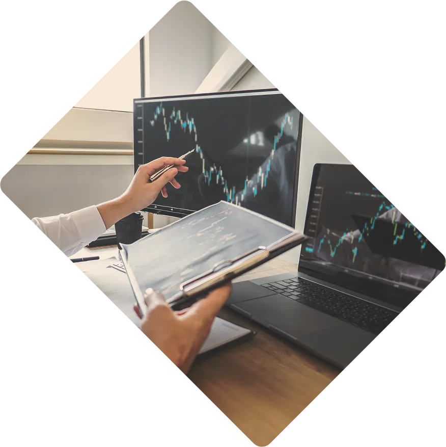 Financial Advisors discussing while pointing at laptop