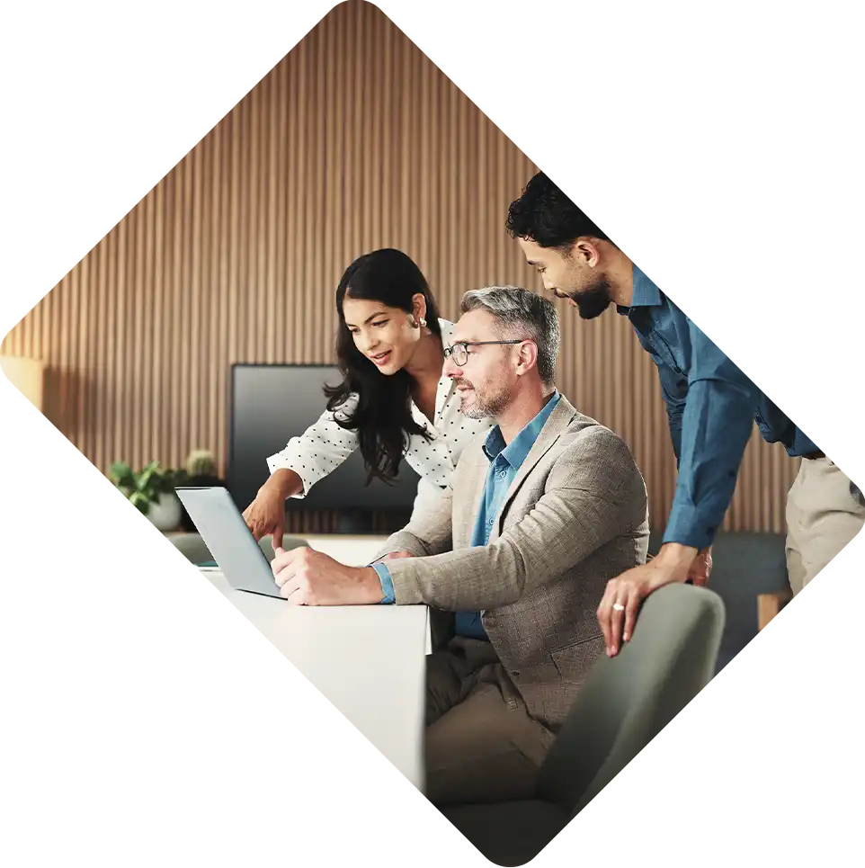 Financial Advisors discussing while pointing at laptop